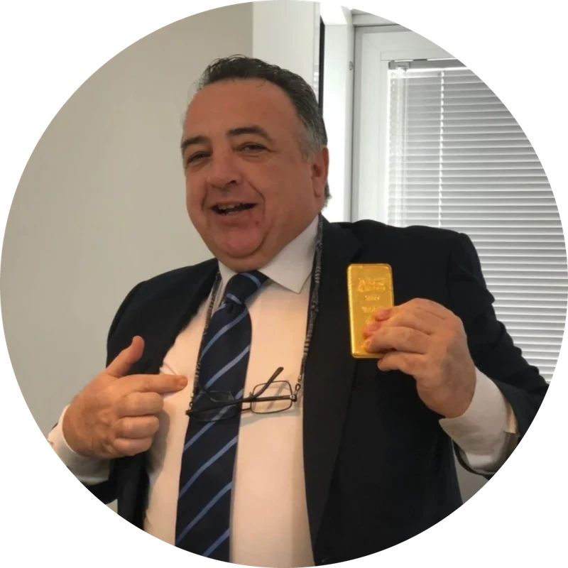 Emilio Corral Romera, smiling, holding a gold bar