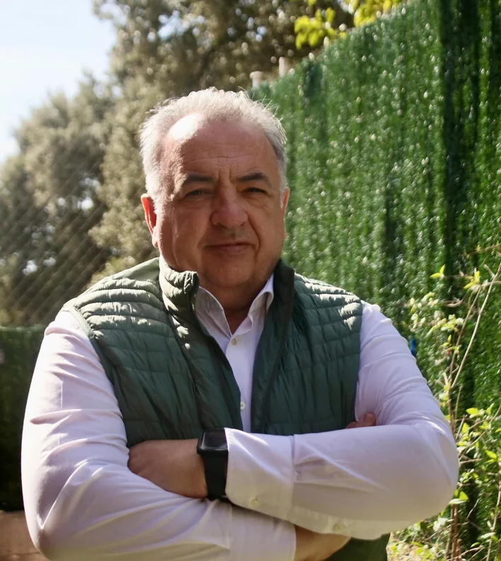 Emilio Corral Romera with arms crossed, outdoors